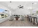Open-concept living space featuring a spacious sitting area, dining area, and a large window at 3315 Elkcam Blvd, Port Charlotte, FL 33952