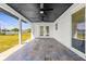 A covered patio features neutral tile flooring and twin ceiling fans at 3315 Elkcam Blvd, Port Charlotte, FL 33952