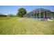 An expansive backyard features a screened-in pool and well-manicured lawn at 347 Casale G St, Punta Gorda, FL 33983