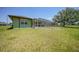 Expansive backyard showing a screened-in pool and patio with lawn extending to the property line at 347 Casale G St, Punta Gorda, FL 33983