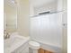 A bathroom features a tub/shower with white tile, a white vanity, and neutral wall color at 347 Casale G St, Punta Gorda, FL 33983