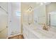 Bathroom featuring a dual sink vanity with marble countertop and a tiled walk-in shower at 347 Casale G St, Punta Gorda, FL 33983