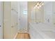 Bright bathroom featuring a double sink vanity with white cabinets and a tiled walk-in shower at 347 Casale G St, Punta Gorda, FL 33983