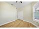 A bedroom with light walls, wood-look flooring, and double closet at 347 Casale G St, Punta Gorda, FL 33983