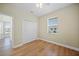 Bedroom with light walls, wood-look flooring, ceiling fan, and double closet at 347 Casale G St, Punta Gorda, FL 33983