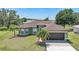 Inviting single-story home showcasing a well-manicured lawn and charming front yard landscaping at 347 Casale G St, Punta Gorda, FL 33983