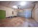 Spacious garage with a roll up door and green door to the house at 347 Casale G St, Punta Gorda, FL 33983