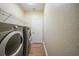 Laundry room with washer, dryer, wire rack and wood-look tile flooring at 347 Casale G St, Punta Gorda, FL 33983