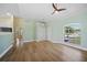 Well-lit living room with tile floors, a ceiling fan, closet, and large window overlooking the front yard at 347 Casale G St, Punta Gorda, FL 33983