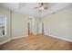 A spacious main bedroom with wood-look floors, tray ceiling, ceiling fan and walk-in closet at 347 Casale G St, Punta Gorda, FL 33983