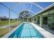 A beautiful screened-in pool with clear blue water, alongside a patio and adjacent to a well-maintained lawn at 347 Casale G St, Punta Gorda, FL 33983
