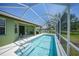 A screened-in pool with steps leading into the clear water at 347 Casale G St, Punta Gorda, FL 33983