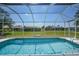 Beautiful blue pool with screened-in enclosure offering backyard views at 347 Casale G St, Punta Gorda, FL 33983