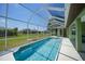 Sparkling blue screened-in pool with patio area and well-maintained backyard at 347 Casale G St, Punta Gorda, FL 33983