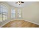 A room with light walls, wood-look floors, two arched windows, and a ceiling fan at 347 Casale G St, Punta Gorda, FL 33983