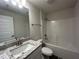Bathroom featuring a single sink vanity with granite countertops and a shower-tub combo at 411 Paramaribo St, Punta Gorda, FL 33983