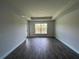 Serene bedroom with a tray ceiling, wood-look tile, neutral walls, and a view of the lake at 411 Paramaribo St, Punta Gorda, FL 33983