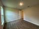 Bedroom featuring wood-look tile flooring and an adjacent doorway with 5-panel door at 411 Paramaribo St, Punta Gorda, FL 33983