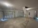 Large 2-car garage with two bay doors and a pull-down ladder to attic storage at 411 Paramaribo St, Punta Gorda, FL 33983