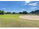 Picturesque golf course view with green fairway, sand trap, and a yellow flag at 411 Paramaribo St, Punta Gorda, FL 33983