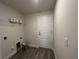Neutral laundry room with utility connections, shelf, and wood-look tile flooring at 411 Paramaribo St, Punta Gorda, FL 33983