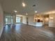 Inviting living space with open floor plan, wood-look tile, and seamless flow to the kitchen at 411 Paramaribo St, Punta Gorda, FL 33983