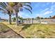 View of a spacious backyard with a fence and access to the canal and waterfront at 4213 Gardner Dr, Port Charlotte, FL 33952