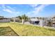 A fenced backyard that slopes down to a canal with a large boat docked at 4213 Gardner Dr, Port Charlotte, FL 33952