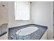 A standalone tub with granite surround that offers a luxurious retreat in this elegant bathroom at 4213 Gardner Dr, Port Charlotte, FL 33952