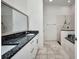 Bathroom featuring a double vanity with a granite countertop and walk-in shower at 4213 Gardner Dr, Port Charlotte, FL 33952