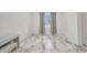 Simple bedroom with marble floors, bright window, and neutral wall color at 4213 Gardner Dr, Port Charlotte, FL 33952