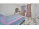Cozy bedroom featuring a colorful bedspread, ample natural light and stylish decor at 4213 Gardner Dr, Port Charlotte, FL 33952