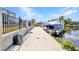 This concrete dock includes a boat lift ready for a boat and canal access at 4213 Gardner Dr, Port Charlotte, FL 33952