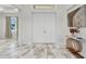 Bright entryway featuring a marble floor, double doors, and elegant decorative accents at 4213 Gardner Dr, Port Charlotte, FL 33952