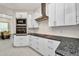 Modern kitchen featuring stainless steel appliances and granite countertops, ample cabinet space at 4213 Gardner Dr, Port Charlotte, FL 33952