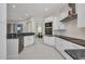 Bright kitchen with stainless steel appliances and granite countertops open to the dining area at 4213 Gardner Dr, Port Charlotte, FL 33952