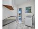 Laundry room with updated cabinetry, marble look tile floors, and a pool view from the window at 4213 Gardner Dr, Port Charlotte, FL 33952
