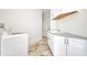 Modern laundry room with updated cabinetry, countertops, flooring and a washer and dryer at 4213 Gardner Dr, Port Charlotte, FL 33952