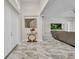 Open-concept living room with marble floors flowing into the foyer and a view to the backyard at 4213 Gardner Dr, Port Charlotte, FL 33952