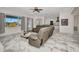 Bright living room with comfortable seating, tile floors, and access to the outdoor pool area at 4213 Gardner Dr, Port Charlotte, FL 33952