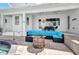 Back patio with outdoor lounge seating, a fire pit, and fans that is perfect for entertaining by the pool at 4213 Gardner Dr, Port Charlotte, FL 33952