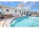 Screened-in pool with a hot tub and outdoor patio space, perfect for entertaining guests at 4213 Gardner Dr, Port Charlotte, FL 33952