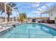 Backyard pool with screened enclosure, small waterfall, and tropical landscaping at 4213 Gardner Dr, Port Charlotte, FL 33952