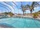 Relaxing backyard pool with tropical landscaping, hot tub, and screened enclosure at 4213 Gardner Dr, Port Charlotte, FL 33952