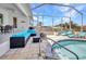 Relaxing screened-in patio with a hot tub, fire pit, and stylish outdoor furniture at 4213 Gardner Dr, Port Charlotte, FL 33952