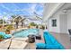 Screened-in pool with spa and sun shelf, surrounded by travertine and outdoor seating at 4213 Gardner Dr, Port Charlotte, FL 33952