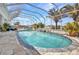 Sparkling pool with screened enclosure, beautiful landscaping, and ample sunlight at 4213 Gardner Dr, Port Charlotte, FL 33952