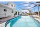 Large, screened-in pool with spa and ample patio space for lounging and entertaining at 4213 Gardner Dr, Port Charlotte, FL 33952
