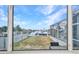 Stunning view overlooking a screened in pool area and canal, seen through a large picture window at 4213 Gardner Dr, Port Charlotte, FL 33952