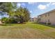 A well-maintained backyard featuring a lush lawn and mature landscaping at 5800 Sabal Trace Dr # 1302, North Port, FL 34287